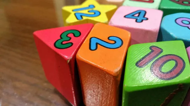 Photo: Some coloured children's toy blocks with numbers on them 