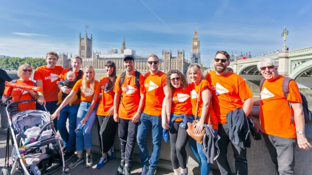 a group of MS fundraisers cheering with smiling faces in london