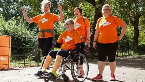 Photo: 4 women in MS T shirts on a fundraising walk 