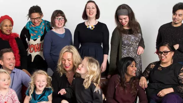 A photo of a group of people laughing and smiling