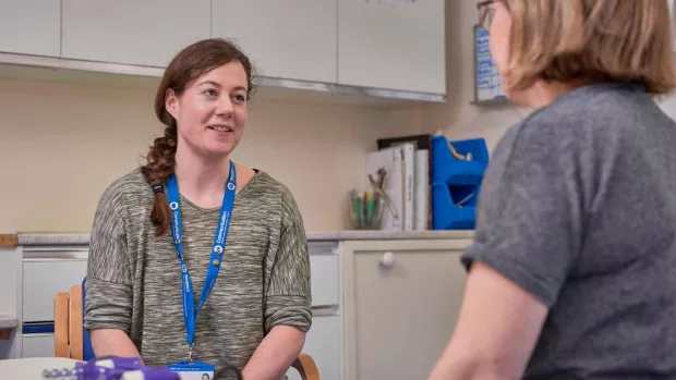 Photo: A woman with ms talking to a healthcare professional