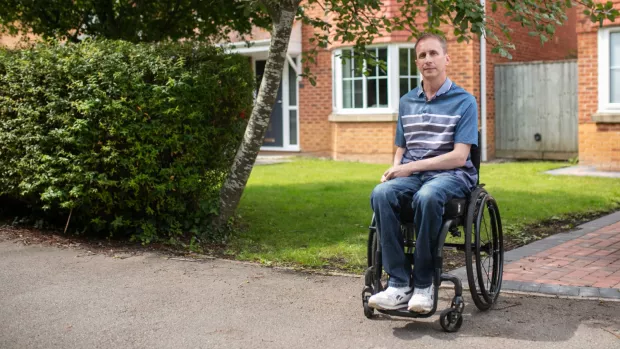 Ben in his wheelchair outside his house