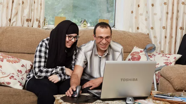 Couple at home on laptop
