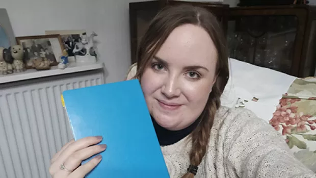 Hannah holding bullet journals