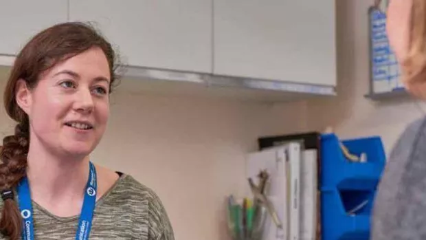 Photo: Woman with MS talking to health care professional