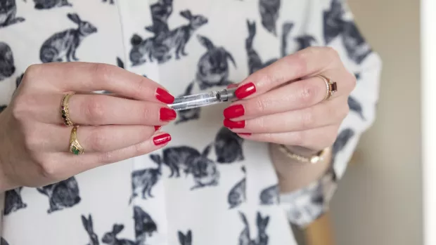Photo: Close up of Kirsty's hand holding her treatment