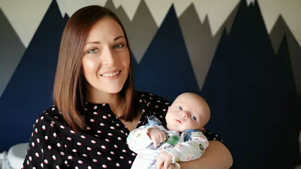 Nicola smiles as she holds baby Alexander in her arms