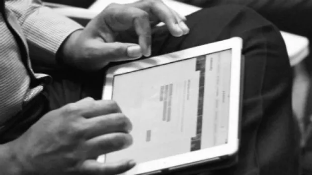 a Picture of a person completing a questionnaire  on a tablet