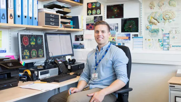 Photo: Researcher in his office, smiling