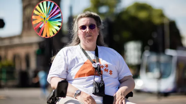 Rhona outside in wheelchair wearing sunglasses
