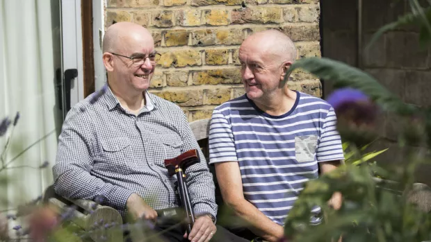 Two men sitting garden