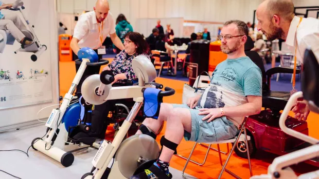 Chair user Glyn does leg strengthening exercises with others with MS 