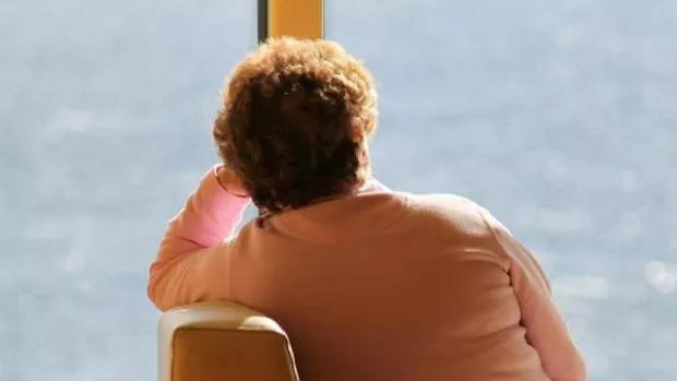 Woman staring out of the window representing a person with MS who has depression