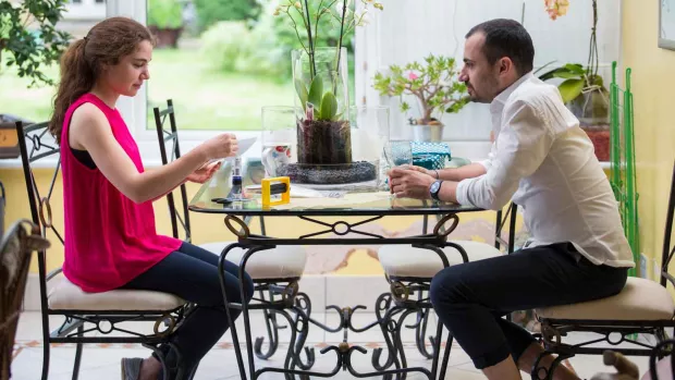 Photo: a Couple sat in a conservatory