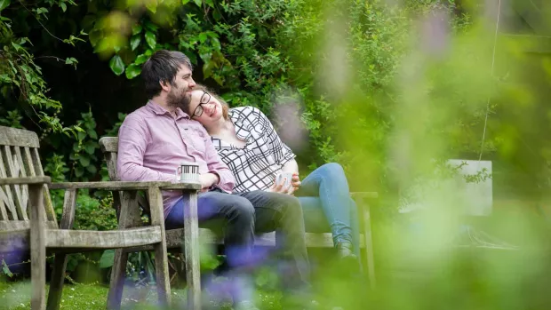 a Couple in garden sat on a bench