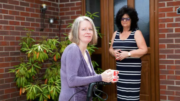 Photo: two Women outside a house