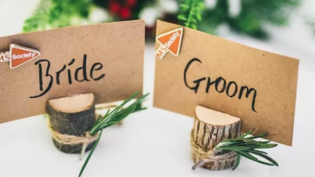 Bride and Groom place names on wedding table with MS Society logos