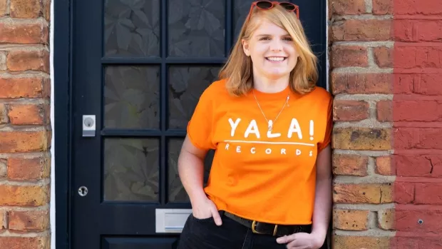 Laura outsite wearing an orange t-shirt