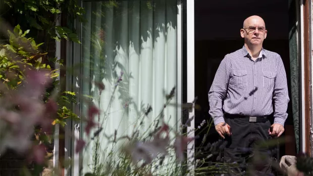 Photo: Man looking thoughtful in the garden