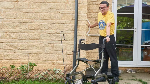 Man outside with walker roller