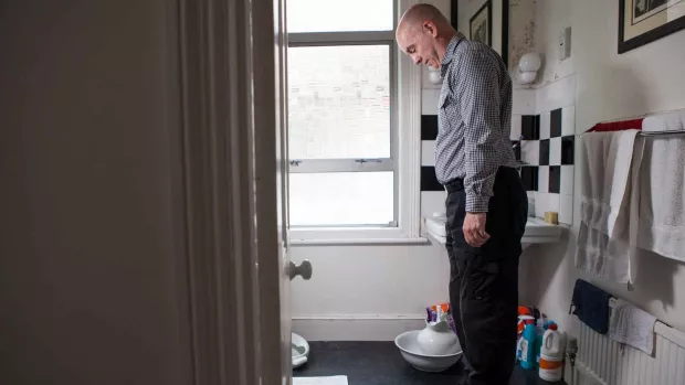 Photo: Man weighing himself