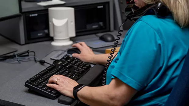 Image shows an MS nurse using a computer