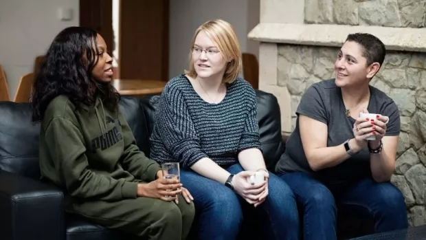 Members of MS Society's Croydon Group chatting on a sofa