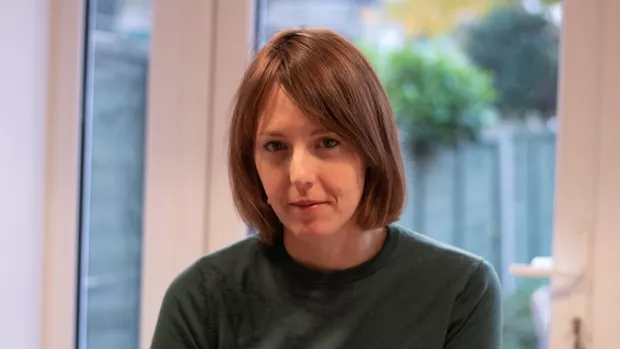 Rachel Cooper wearing a black top with garden window in the background