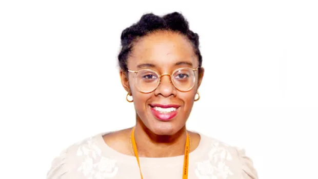 A portrait of Tamal Willie, she is wearing glasses and smiling