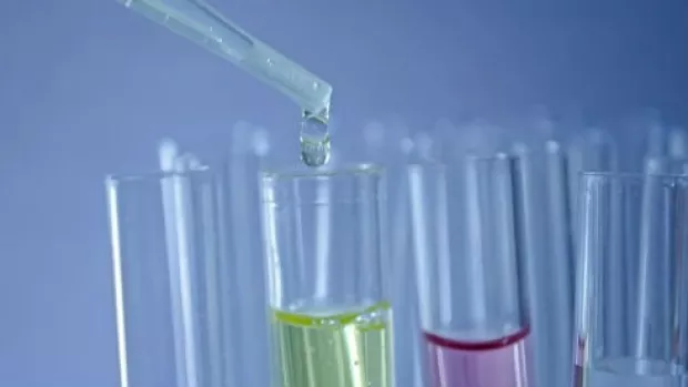 Image shows various test tubes with a pipette