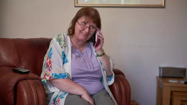 Photo: Woman at home on the phone