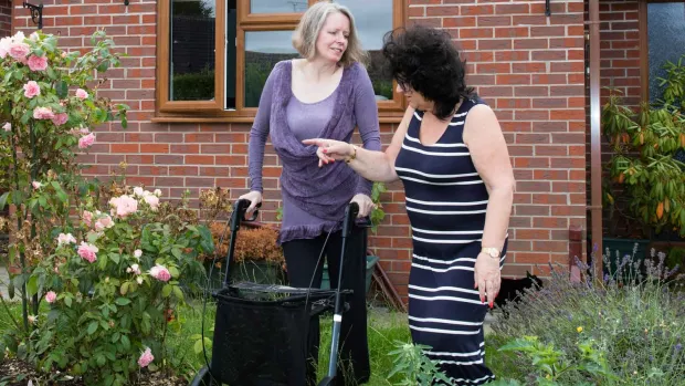 Photo: Two Women talking  in a garden