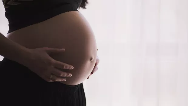 Pregnant woman holding her stomach