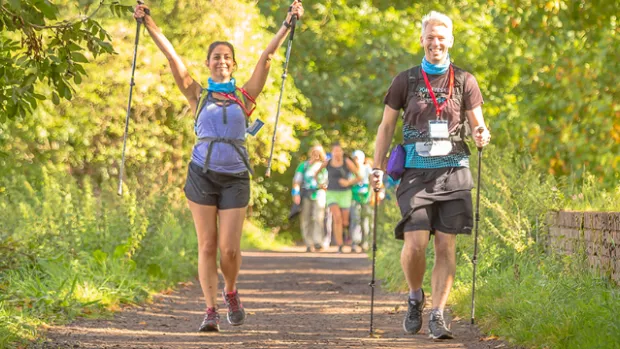 Two people walk the Thames Path Challenge