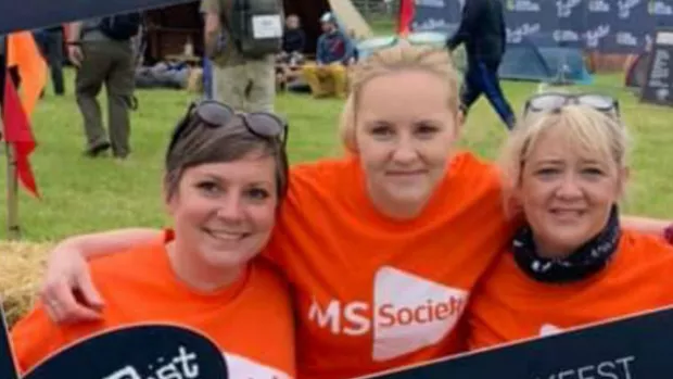 Group of people smiling while taking part in a local MS walking challenge