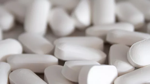 White tablets spread across a table