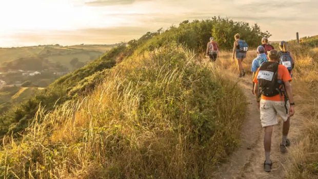 View of walkers through Yorkshire at sunset