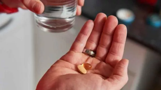 Close up of hand holding some pills