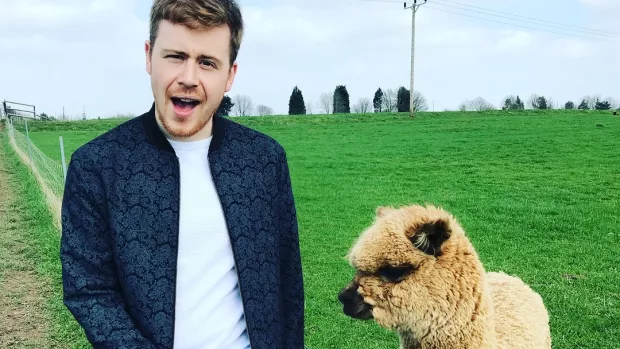 Photo of Robin Hatcher with an alpaca 