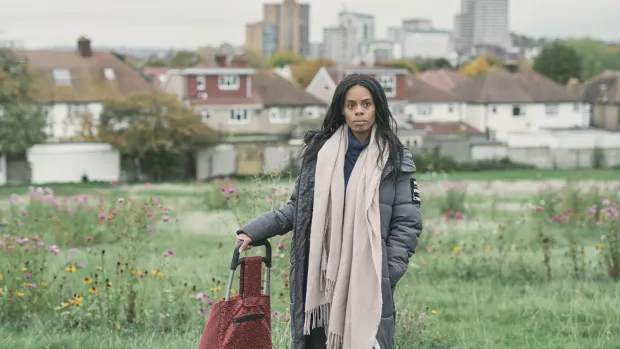 Image shows Brieann standing with cityscape behind her.