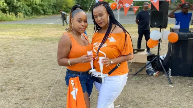 Two fundraisers wearing My MS Walk t-shirts holding drinks