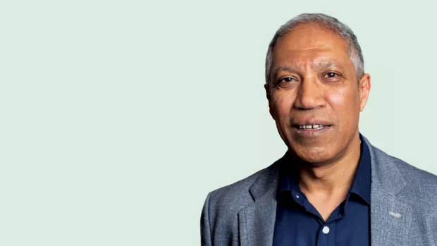 Image of Professor Max Parmar smiling against a blue background.