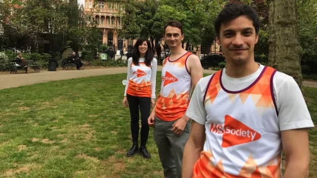 Three researchers standing outside wearing MS Society t-shirts