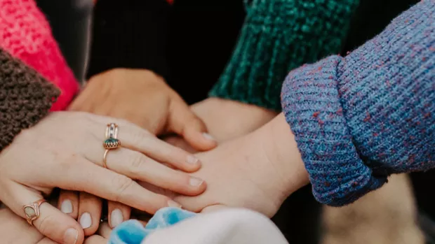 Hands piled together