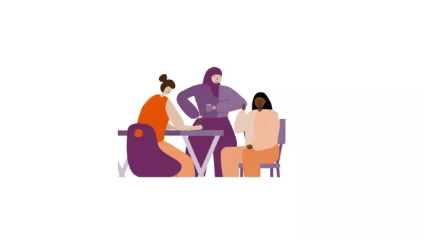 3 people work together around a table