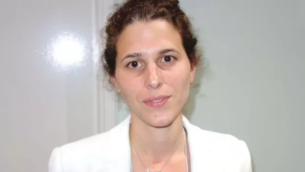 Dr Yael Hacohen, a woman in a white blazer with dark hair and brown eyes