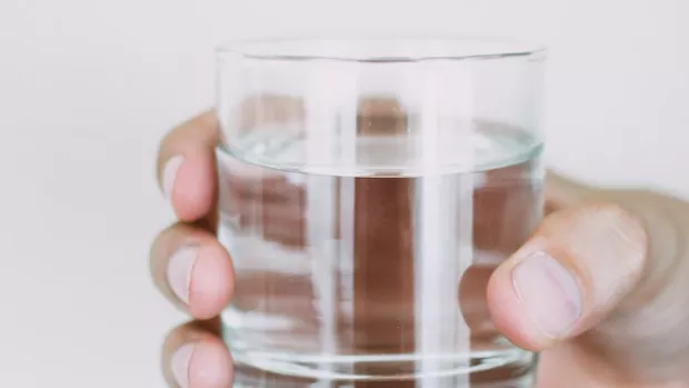 a glass of water being held up