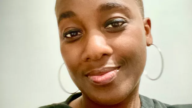 close up of a smiling woman with large hoop earrings 