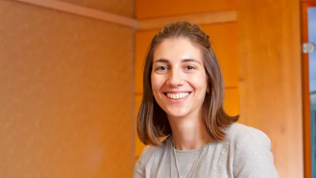 A headshot of Angeliki Bogosian smiling at the campera