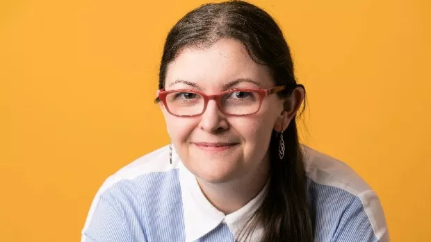 Photo of Kate Laverty against an orange background